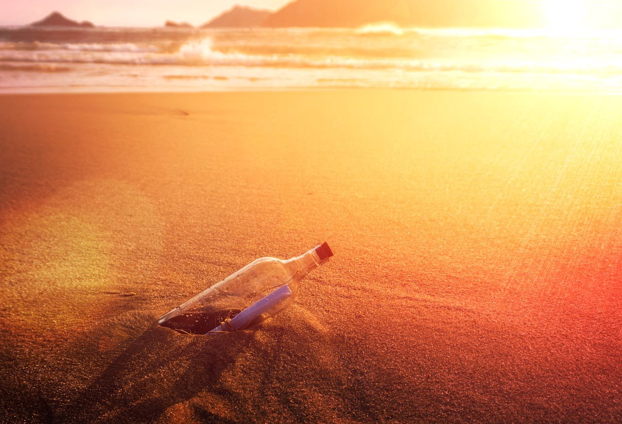 A romantic message in a bottle on the sandy shore of Rio de Janeiro at sunset.